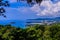 Beautiful landscape of turquoise ocean waves with boats, coastline and blue sky background from high aerial view point