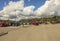 Beautiful landscape view. Cars on parking spot on gorgeous blue sky with white clouds background