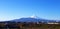 Beautiful landscape view of Fuji mountain and clear blue sky with many roof home and grass field for foreground.