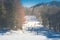 Beautiful landscape view of Mountain covered with white snow and people skiing on white snow at ski resort.