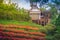 Beautiful landscape view of red flower garden and the small cottage in the forest at Bhubing palace, Chiang Mai, Thailand.