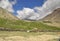 Beautiful landscape view of a tiny village in between dry mountains on the way of Darcha-Padum road, Ladakh