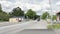 Beautiful landscape view of typical swedish country village on cloudy summer day. People crossing asphalt road.