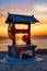 Beautiful landscape of a well with a wheel in the sunrise near the Razelm Lake