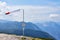 Beautiful landscape with windsock and mountains on background and blue sky in Austrian Alps