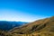 Beautiful landscape of a yellow grassland blue sky and Alps mountain at sunset. I