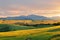 Beautiful landscape of yellow paddy field and mountain at sunset.