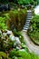 Beautiful landscapes of a green garden with paths, with a staircase and a pond. Sintra, day, Portugal