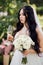 Beautiful, with a large bust, the bride in a wedding dress poses for the camera. Girl in white dress