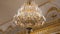 Beautiful large crystal chandelier in a royal environment. Interior elements - decorated ornate ceiling large luxury