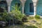 Beautiful and large fountain and lake of a patio terrace outside a Mexican hacienda with flags.