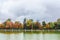 Beautiful large lake and colorful autumn trees in the Buen Retiro Park near the Monument to Alfonso XII. Madrid, Spain