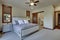 Beautiful large luxury new bedroom with great design, beige, grey and white tones, TV bove dresser, rich wooden doors, window