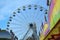 Beautiful large observation wheel in amusement park against blue sky