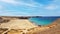 Beautiful large wide secluded idyllic empty sand beach lagoon, turquoise sea, dry hills dunes, rocks - Playa Mujeres, Ponte