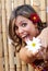 Beautiful latin smiling woman with a flower