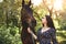 Beautiful Latin woman in dress and her lovely horse walk in the forest. love animals concept. love horses