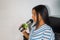 Beautiful Latina Hispanic young woman drinking water bottle at home