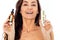 Beautiful laughing caucasian woman holding mock ups of white tube and brown serum bottle