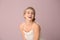 Beautiful laughing woman with nude makeup on color background