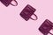 Beautiful leather purple handbags on a pink paper background  in zine style
