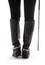 Beautiful legs in black leather horseman boots with riding-crop