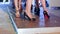 Beautiful legs of models in black footwear go along catwalk on fashion show