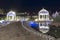 Beautiful leisure park with two gazebos and wooden bridge over water with night lighting. North Cyprus landscape