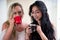 Beautiful lesbians lovers at morning, blonde and brunette girls are drinking coffee, in a white background