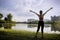 Beautiful life. Happy people lifestyle. Young woman in a nature park setting with her arms up in the air feeling free and energize