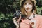 Beautiful lifestyle portrait of young adult woman with vintage film camera outdoors