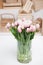 Beautiful light rosy tulips in glass vase