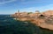 Beautiful lighthouse on the pink rocks