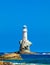 The beautiful Lighthouse Tourlitis of Chora at night. Andros island, Cyclades, Greece