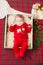 Beautiful little baby celebrates Christmas. New Year`s holidays. Baby in a Christmas costume