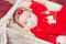 Beautiful little baby celebrates Christmas. New Year`s holidays. Baby in a Christmas costume