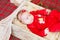 Beautiful little baby celebrates Christmas. New Year`s holidays. Baby in a Christmas costume