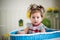 Beautiful little brown-eyed girl sits in basket