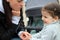 beautiful little cheerful smiling girl with her mother on a walk in the street