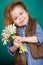 Beautiful little girl with a big bouquet of snowdrops.