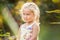 Beautiful little girl blonde smiles on a colorful background