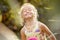 Beautiful little girl blonde smiles on a colorful background