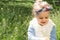 Beautiful little girl blowing dandelion. Cute girl on the medow