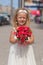 Beautiful little girl with bouquet of roses in her