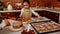 Beautiful little girl in chef apron plays, kneads dough, prepares gingerbread cookies for Christmas in the home kitchen