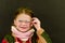Beautiful little girl with glasses on black background. Funny cute girl with glasses. Small girl wears colorful sweater.
