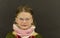 Beautiful little girl with glasses on black background. Funny cute girl with glasses. Small girl wears colorful sweater.