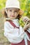 Beautiful little girl with grapes. Child with fruit.