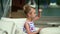 The beautiful little girl model is photographed on the boat at a pier. The small model poses on the boat.