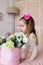 Beautiful little girl playing with artificial colorful flowers o